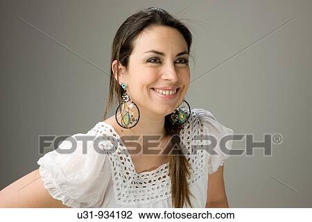 Latin woman smiling, looking away from camera View Large Photo Image Stock Image - Latin woman smiling, looking away from camera. Fotosearch