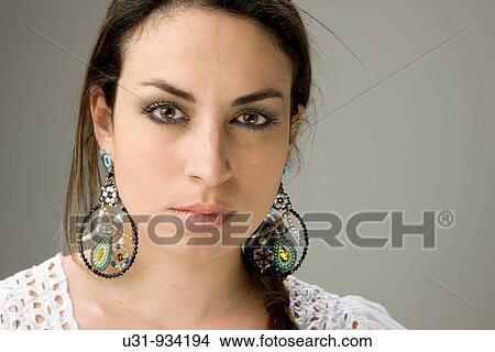Picture - Latin woman with big brown eyes looking at the camera. Fotosearch