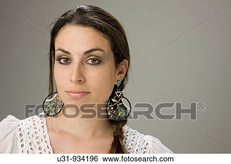 Stock Photograph - Latin woman with big brown eyes looking at the camera. Fotosearch