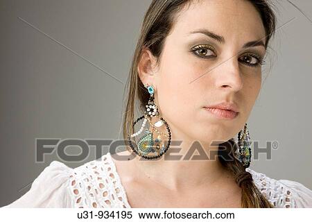 Stock Photography - Latin woman with big brown eyes looking at the camera. Fotosearch