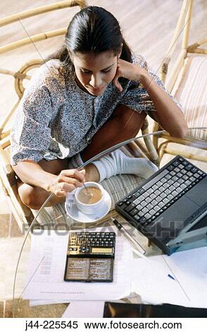 Latin woman working with laptop computer and cup of coffee in the house terrace View Large Photo Image Stock Photography - Latin woman working with laptop computer and cup of coffee in the house terrace. Fotosearch