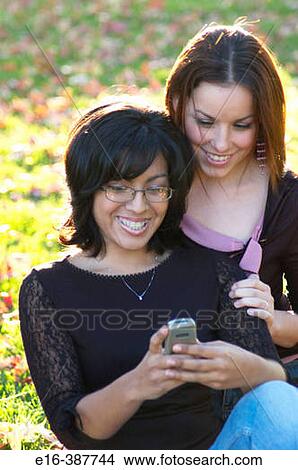 Latin women using a cell phone View Large Photo Image Picture - Latin women using a cell phone. Fotosearch