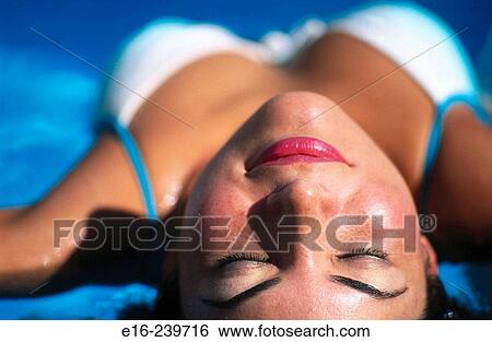 Latino lady sunbathing View Large Photo Image Stock Photograph - Latino lady sunbathing. Fotosearch