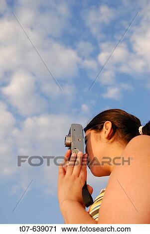 Latino Woman holding a camera. View Large Photo Image Stock Image - Latino Woman holding a camera.. Fotosearch