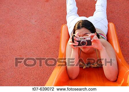 Latino Woman holding a camera. View Large Photo Image Stock Image - Latino Woman holding a camera.. Fotosearch