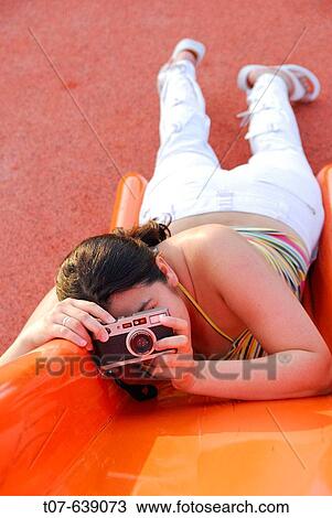 Latino Woman holding a camera. View Large Photo Image Stock Image - Latino Woman holding a camera.. Fotosearch