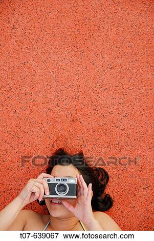 Latino Woman holding a camera. View Large Photo Image Stock Photo - Latino Woman holding a camera.. Fotosearch
