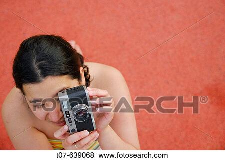 Latino Woman holding a camera. View Large Photo Image Stock Photo - Latino Woman holding a camera.. Fotosearch