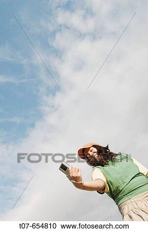 Latino woman holding digital camera. View Large Photo Image Stock Image - Latino woman holding digital camera.. Fotosearch