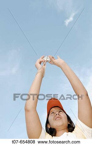 Latino woman holding digital camera. View Large Photo Image Stock Photo - Latino woman holding digital camera.. Fotosearch