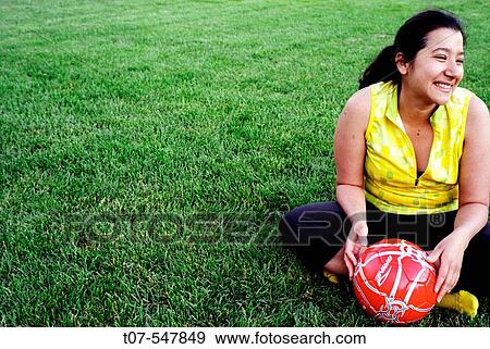Latino woman holding soccer ball - football View Large Photo Image Stock Photo - Latino woman holding soccer ball - football. Fotosearch