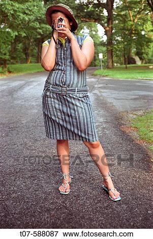 Latino woman holding video camera. View Large Photo Image Stock Photo - Latino woman holding video camera.. Fotosearch