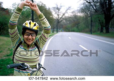 Latino woman on a bicycle, Central Park, Manhattan, New York City View Large Photo Image Stock Image - Latino woman on a bicycle, Central Park, Manhattan, New York City. Fotosearch