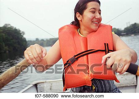 Latino woman rowing boat. View Large Photo Image Stock Image - Latino woman rowing boat.. Fotosearch