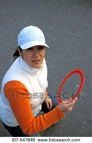 Latino woman throwing a Frisbee. View Large Photo Image Stock Photograph - Latino woman throwing a Frisbee.. Fotosearch