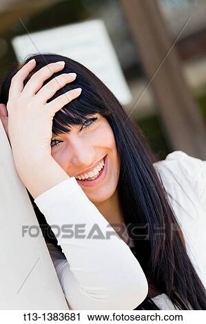 Laughing and holding head young woman View Large Photo Image Stock Image - Laughing and holding head young woman. Fotosearch