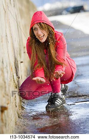 Laughing and water throwing pretty girl in Red View Large Photo Image Picture - Laughing and water throwing pretty girl in Red. Fotosearch