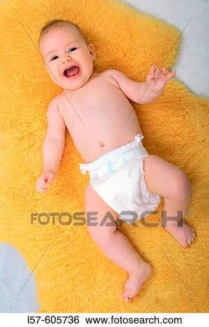 Laughing baby lying on back, on sheep skin, Studio, Oetwil am See, Zuerich, Switzerland View Large Photo Image Stock Photograph - Laughing baby lying on back, on sheep skin, Studio, Oetwil am See, Zuerich, Switzerland. Fotosearch