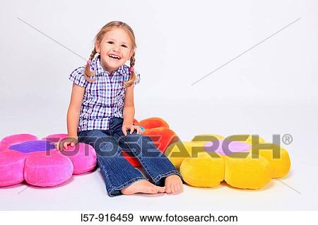 laughing little girl sitting on cushions, Switzerland View Large Photo Image Stock Photo - laughing little girl sitting on cushions, Switzerland. Fotosearch