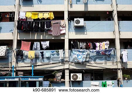 Laundry hanging from balconies equipped with air conditions at residential buildings of middle class dwellers, Bangkok, Thailand, Southeast Asia View Large Photo Image Stock Image - Laundry hanging from balconies equipped with air conditions at residential buildings of middle class dwellers, Bangkok, Thailand, Southeast Asia. Fotosearch