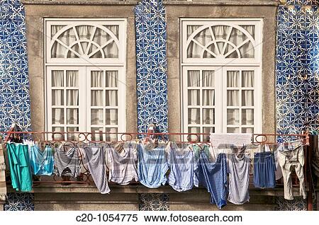 laundry hanging from window, typical quarter of Ribeira, Porto, Portugal View Large Photo Image Stock Photography - laundry hanging from window, typical quarter of Ribeira, Porto, Portugal. Fotosearch