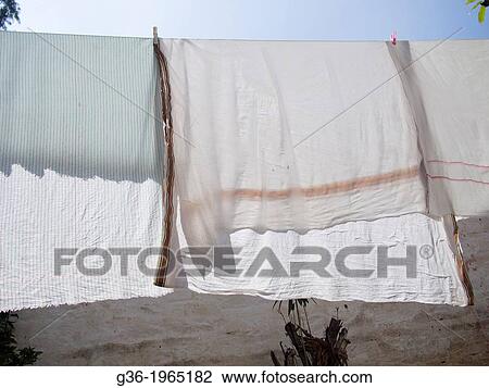 Laundry hangs on a line in Bangalore, Karnataka, India. View Large Photo Image Stock Image - Laundry hangs on a line in Bangalore, Karnataka, India.. Fotosearch