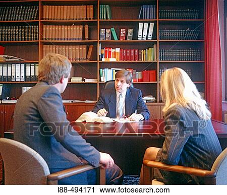 Stock Image - Lawyer with two clients.. Fotosearch