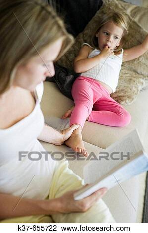 Lazy afternoon. 4 y/o daughter relaxing with mother on sofa. View Large Photo Image Stock Image - Lazy afternoon. 4 y/o daughter relaxing with mother on sofa.. Fotosearch