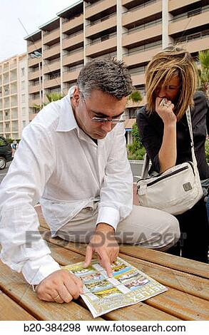 Leafing through a property state magazine. Hendaye. Aquitaine. France. View Large Photo Image Stock Photo - Leafing through a property state magazine. Hendaye. Aquitaine. France.. Fotosearch