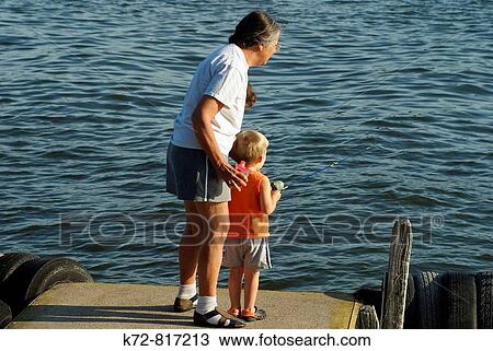Learning to fish on a summer day with supervision by the boy's Grandmother. View Large Photo Image Stock Image - Learning to fish on a summer day with supervision by the boy's Grandmother.. Fotosearch