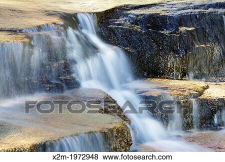 Stock Photo - Ledge Brook during the spring months in the White Mountains, New Hampshire USA. This brook is located off of the Kancamagus Scenic Byway.. Fotosearch