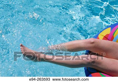legs of 13 year old girl in a swimming pool floating in an inflatable tube View Large Photo Image Stock Image - legs of 13 year old girl in a swimming pool floating in an inflatable tube. Fotosearch