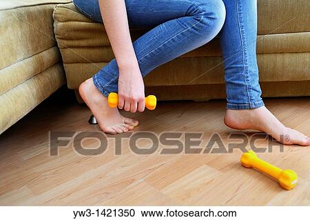legs of a young caucasian woman in jeans with dumbbells in hand View Large Photo Image Stock Image - legs of a young caucasian woman in jeans with dumbbells in hand. Fotosearch