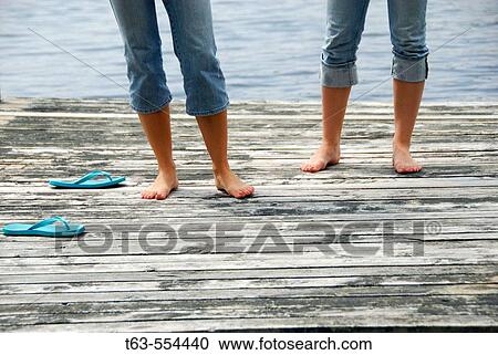legs of girl 13 girl 18 standing on dock together View Large Photo Image Stock Image - legs of girl 13 girl 18 standing on dock together. Fotosearch
