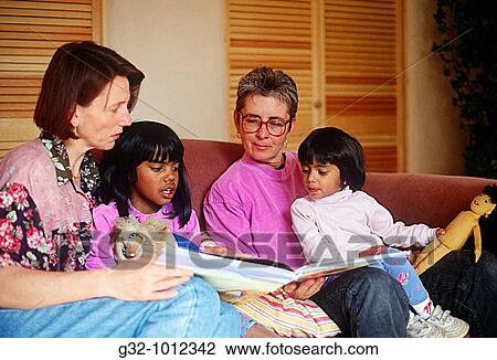 Lesbian parents read with E Indian adopted daughters View Large Photo Image Stock Image - Lesbian parents read with E Indian adopted daughters. Fotosearch