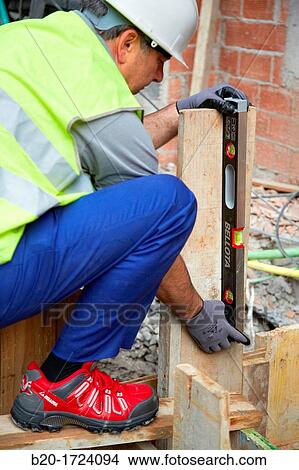 Picture - Level, hand tools for construction, construction worker, Preparation of formwork for construction of pit with concrete, House Construction, Basque Country, Spain. Fotosearch