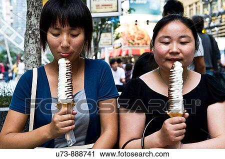 Licking their icecream on a hot summer day, China View Large Photo Image Stock Image - Licking their icecream on a hot summer day, China. Fotosearch