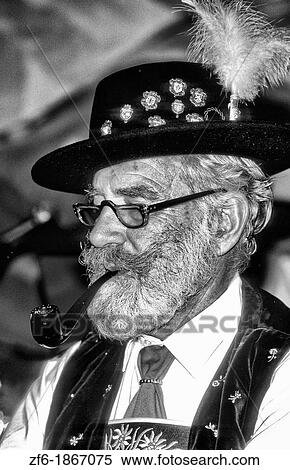 Life in Germany in Bavaria man in traditional clothes at the Hofbrahaus duing Oktoberfest party with beer in Old Town in Munich Germany View Large Photo Image Stock Photography - Life in Germany in Bavaria man in traditional clothes at the Hofbrahaus duing Oktoberfest party with beer in Old Town in Munich Germany. Fotosearch