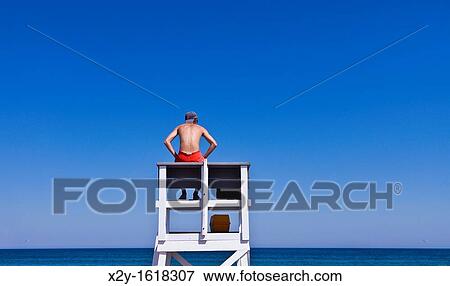 Stock Photo - Lifeguard watches over ocean waters, Cape Cod National Seashore, Cape Cod, MA, Massachusetts, USA. Fotosearch