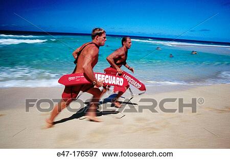Stock Photo - Lifeguards running at the beach. Fotosearch