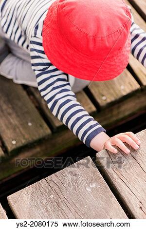 Lifestyle moment of summer childhood. Little girl playing on jetty, Sweden. View Large Photo Image Stock Photography - Lifestyle moment of summer childhood. Little girl playing on jetty, Sweden.. Fotosearch