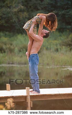 Lifting up his girlfriend View Large Photo Image Stock Photograph - Lifting up his girlfriend. Fotosearch