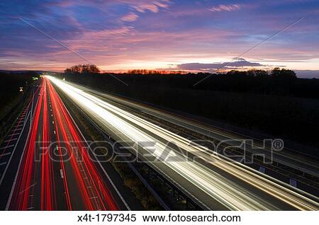 ligh trails at night on a busy main road View Large Photo Image Stock Photography - ligh trails at night on a busy main road. Fotosearch
