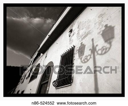 Stock Image - Light post shadow on stucco wall in Sorrento. Italy. Fotosearch