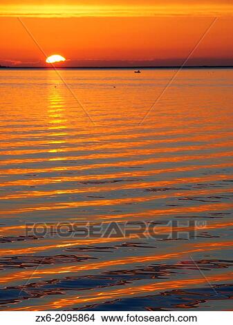 Light reflections over Alfacs Bay at sunrise, seen from Sant Carles de la Rapita fishing port. Ebro Delta Natural Park. Montsia Region, Tarragona Province, Catalonia, Spain. View Large Photo Image Picture - Light reflections over Alfacs Bay at sunrise, seen from Sant Carles de la Rapita fishing port. Ebro Delta Natural Park. Montsia Region, Tarragona Province, Catalonia, Spain.. Fotosearch