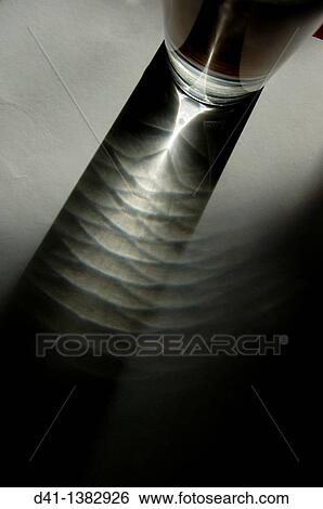 Light refracted through liquid filled glass View Large Photo Image Stock Photograph - Light refracted through liquid filled glass. Fotosearch