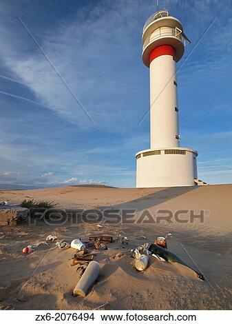 Lighthouse and garbage at Fangar Peninsula. Ebro River Delta Natural Park, Tarragona province, Catalonia, Spain. View Large Photo Image Picture - Lighthouse and garbage at Fangar Peninsula. Ebro River Delta Natural Park, Tarragona province, Catalonia, Spain.. Fotosearch