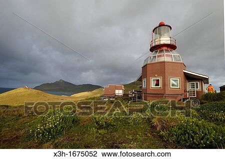 Stock Image - lighthouse of Horn island with the Cape Horn background, Tierra del Fuego, Patagonia, Chile, South America. Fotosearch