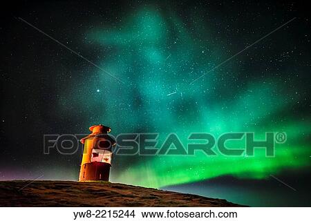 Picture - Lighthouse with Aurora Borealis or Northern Lights, Iceland.. Fotosearch