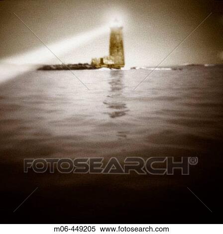 Lighthouse with beam of light toi. the left. View Large Photo Image Stock Photography - Lighthouse with beam of light toi. the left.. Fotosearch